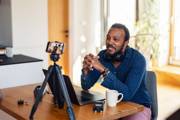 img src="your-image-file-name.jpg" alt="Asian female content creator recording a podcast and reviewing wireless headphones, sitting in a professional studio with microphone and camera setup."
